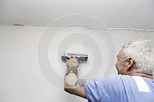 Man spackling a wall