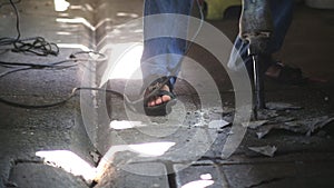 Man with spade machine working and digging a hole in the ground