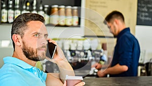 Man speak mobile phone and drink coffee cafe bar background. Man solving problems phone drink coffee. Confident