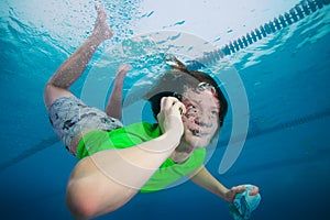 Man speaking on the cell phone underwater