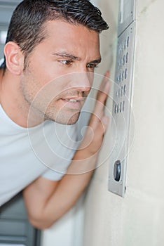 Man speaking into intercom system