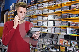man speaking by phone during shopping