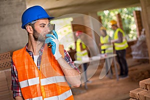 Man speaking on walky talky at site