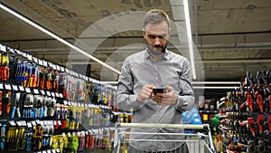 A man speaks on the phone in building store