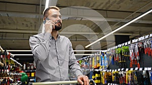 A man speaks on the phone in hardware store