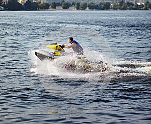 Man speeding on jet ski on lake during summer vacation photo