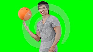 A man spinning a basketball on his hand