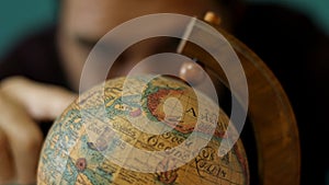 Man spinning a globe.