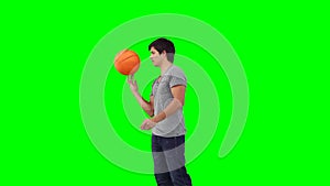 A man spins a basketball on his finger