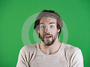 Man splash water at face on green background.