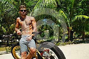 Man With Sport Bike Relaxing On Tropical Beach In Summer