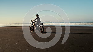 Man on a sportbike driving by an ocean shore