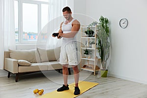 Man sports arm pain muscle and ligament sprain from working out at home, pumped up man fitness trainer works out at home