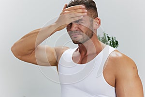 Man sports headache, migraine and dizziness from working out at home, pumped up man fitness trainer works out at home