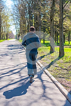 Man in a sports suit running in city park