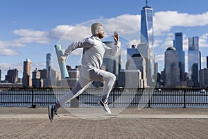 Man sportsman running for exercise in active wear. Sportsman jogger running. Sport runner in Manhattan. The sportsman