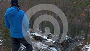 A man in sportswear enjoys beautiful mountain scenery.