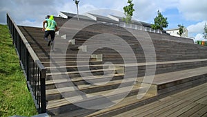 A man in sportswear runs up the wooden steps