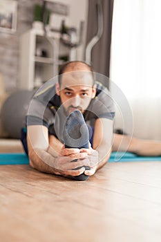 Man in sportswear stretching his legs