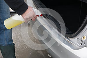 Man Spraying Car Soap for Washing a Car