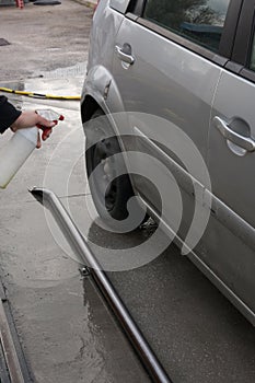 Man Spraying Car Soap for Washing a Car