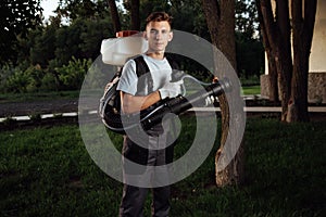 Man spraying insect repellent. Gardener with insect sprayer