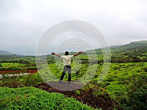 Man spreading arms and enjoying amidst nature