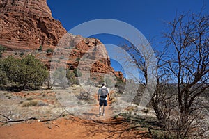 Man on spring hiking trip in red mountains.