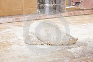 Man sprinkling flour over fresh dough
