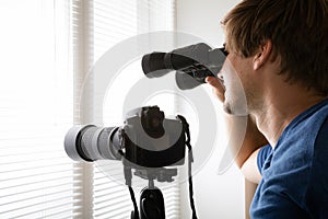 Man Spying With Binoculars