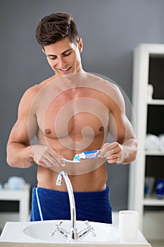 Man squeezes the toothpaste