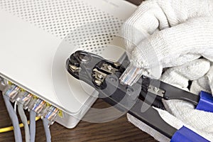 A man is squeezing a chip on a network cable, a modem, the Internet, a close-up