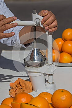 Man squeezing orange juics