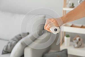 Man squeezing stress ball at home