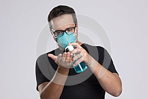 Man  squirting disinfecting soap in his hand.