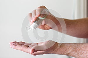 Man Squirting Hand Sanitizer into Hand