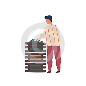 Man stacking vegetables crates flat vector illustration. Young rancher, farm worker cartoon character. Farmer harvesting
