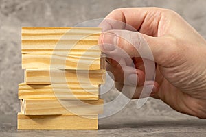 Man stacking wooden blocks, business concept background