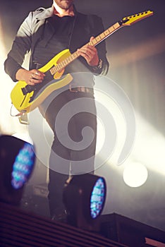 Man, stage and guitar for performance at concert, music festival or live event in Amsterdam. Male artist, electric