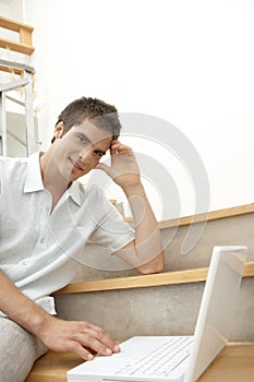 Man on Stairwell With Laptop