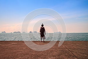 Man stand alone on the sea beach at sunset haze Calm sea