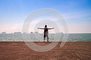 Man stand alone on the sea beach at sunset haze Calm sea