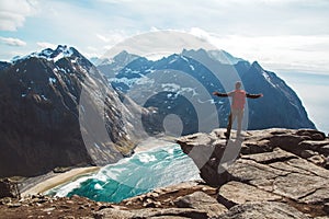 Man stand on cliff edge alone enjoying aerial view backpacking lifestyle travel adventure outdoor vacations