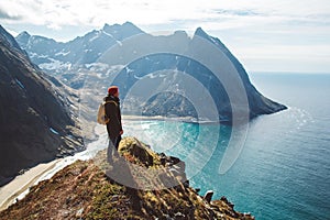 Man stand on cliff edge alone enjoying aerial view backpacking lifestyle travel adventure outdoor vacations