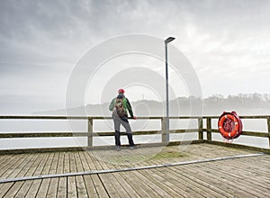 Man stand by the sea winter season. entrepreneur enjoying sunset