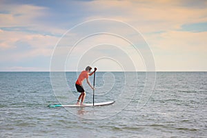 Man on stand up paddle. Water and beach sport