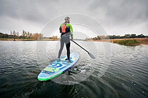 Man on stand up paddleboard photo