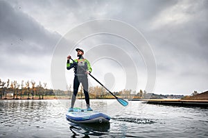 Man on stand up paddleboard photo