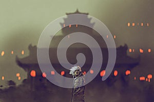 Man standing against ancient temple with red lights