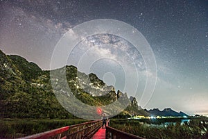 A man standing against milky way and mountain, Thailand